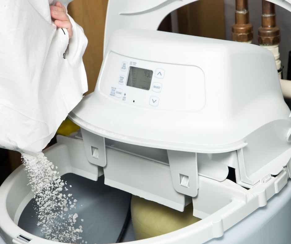 Pouring salt into a water softener